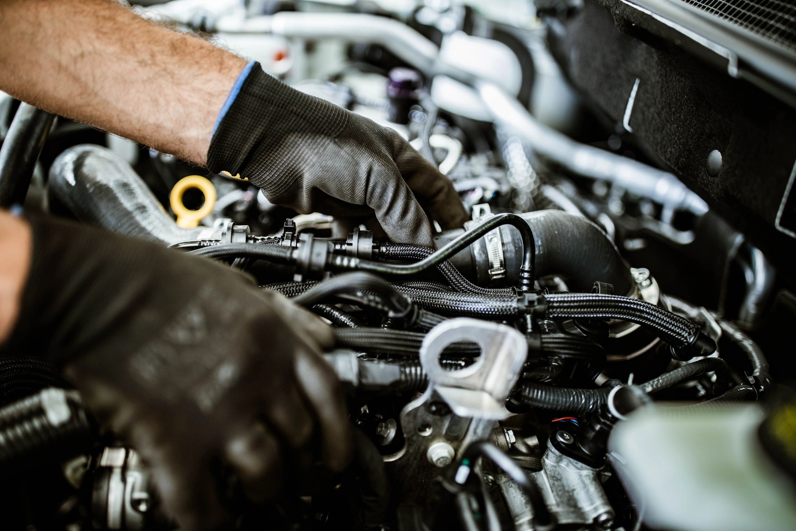 Close-up of a mechanic inspecting an engine component