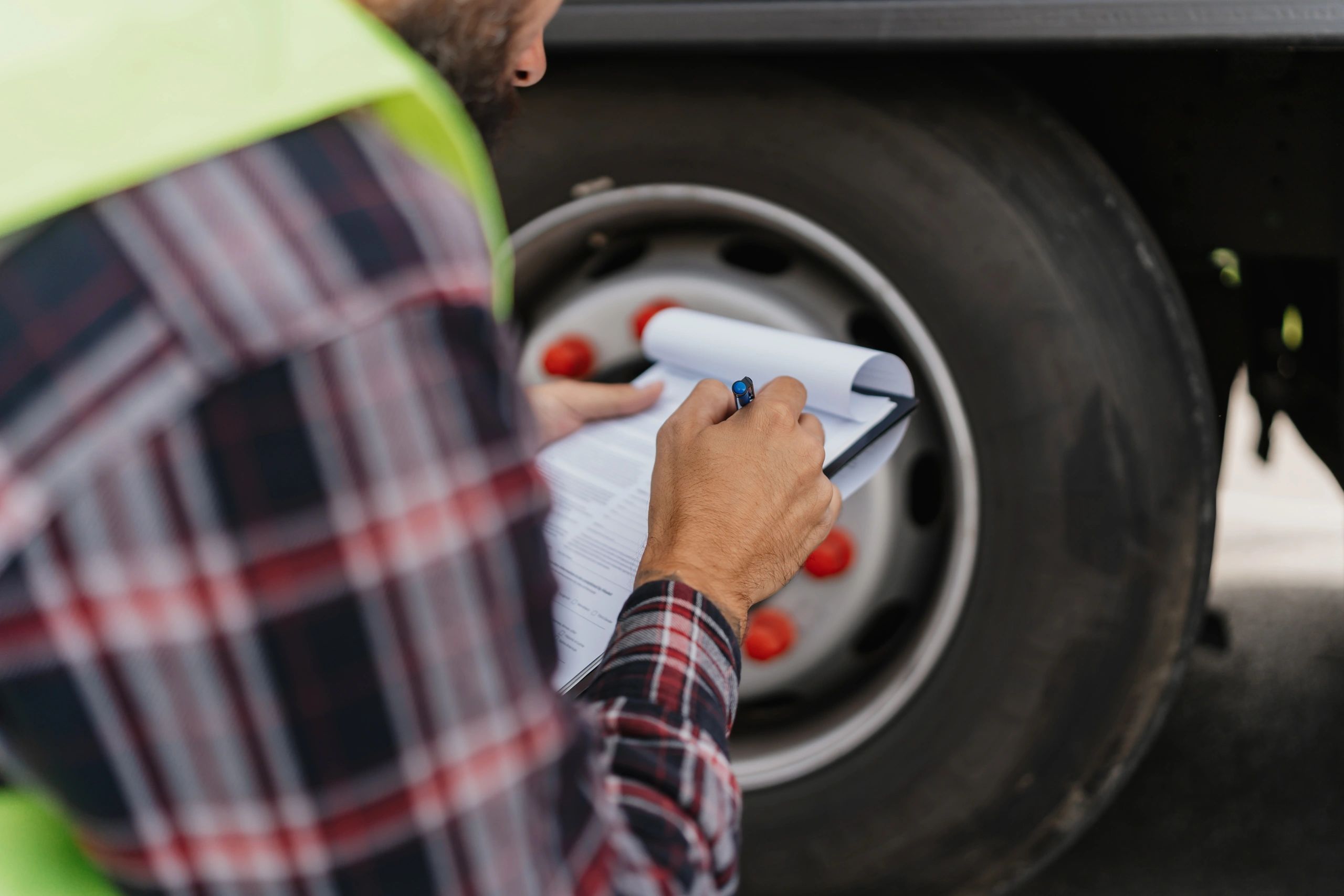 Technician inspecting a truck tire